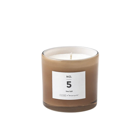 Pretty scented candle in soft toned glass jar for Nordic home style from Bloomingville