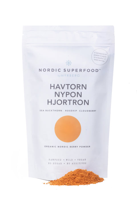 Large white pouch of powdered blend of 100% all natural, handpicked organic wild superfoods from the Nordic nature, with blend of yellow fruits - sea buckthorn, rosehips, cloudberries