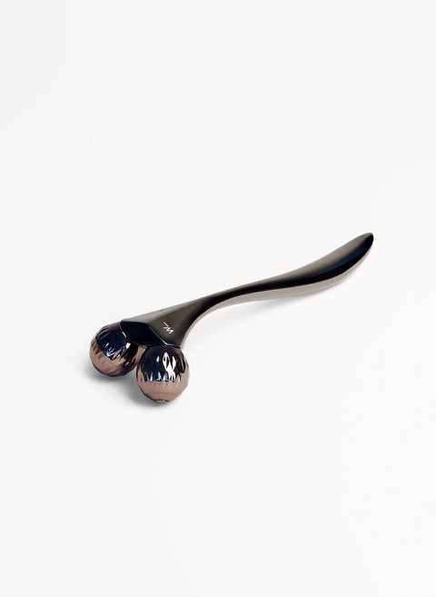 Steel coloured metal sculpting tool with faceted rollers to improve skin tone and circulation, boosting collagen production and for home facial treatments is a great luxury gift for the skincare junkie from Woods Copenhagen.