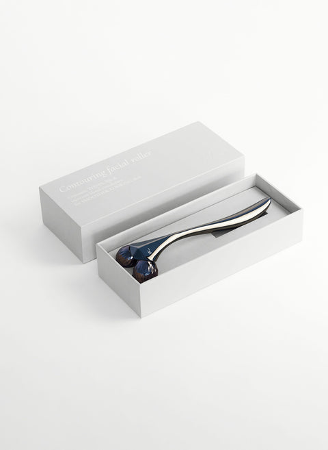 Steel coloured metal sculpting tool with faceted rollers to improve skin tone and circulation, boosting collagen production and for home facial treatments is a great luxury gift for the skincare junkie from Woods Copenhagen.