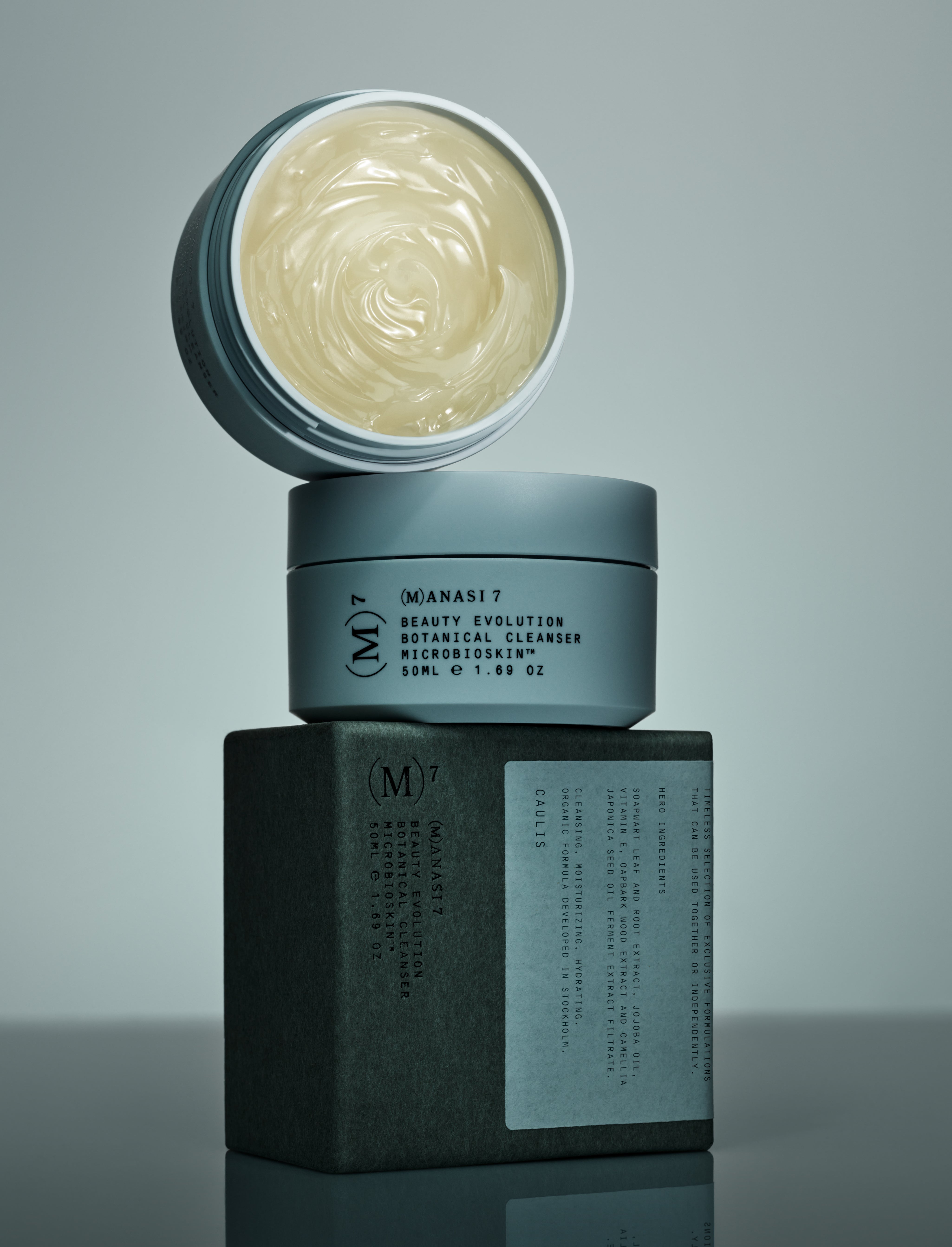 signature white pots with black and white text of organic cleansing balm Caulis with microbiome protection, multi purpose skincare from Manasi7