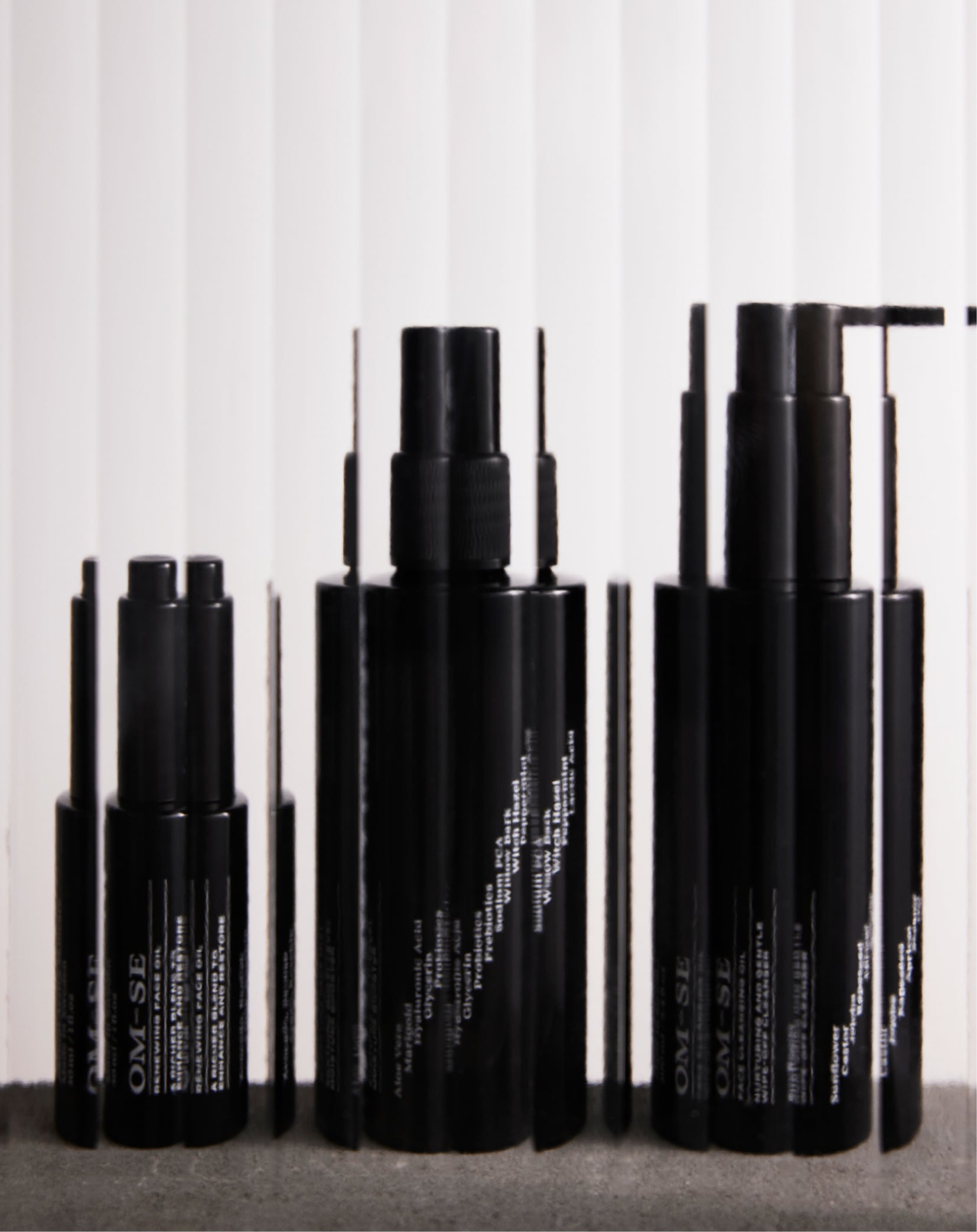 Skincare minimalism in black glass bottles with stark white text from OM-SE. All you need for dry & older skin in one gift box.