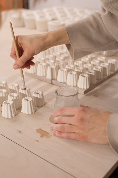 Making ceramic candle holders in large and small sizes with choice of glaze colours, to hold thin beeswax taper candles by Ovo Things