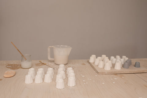 Making ceramic candle holders in large and small sizes with choice of glaze colours, to hold thin beeswax taper candles from Ovo Things