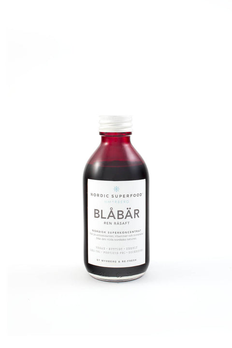 Glass bottle of pure, concentrated raw pressed blueberry health shot from Nordic Superfoods.