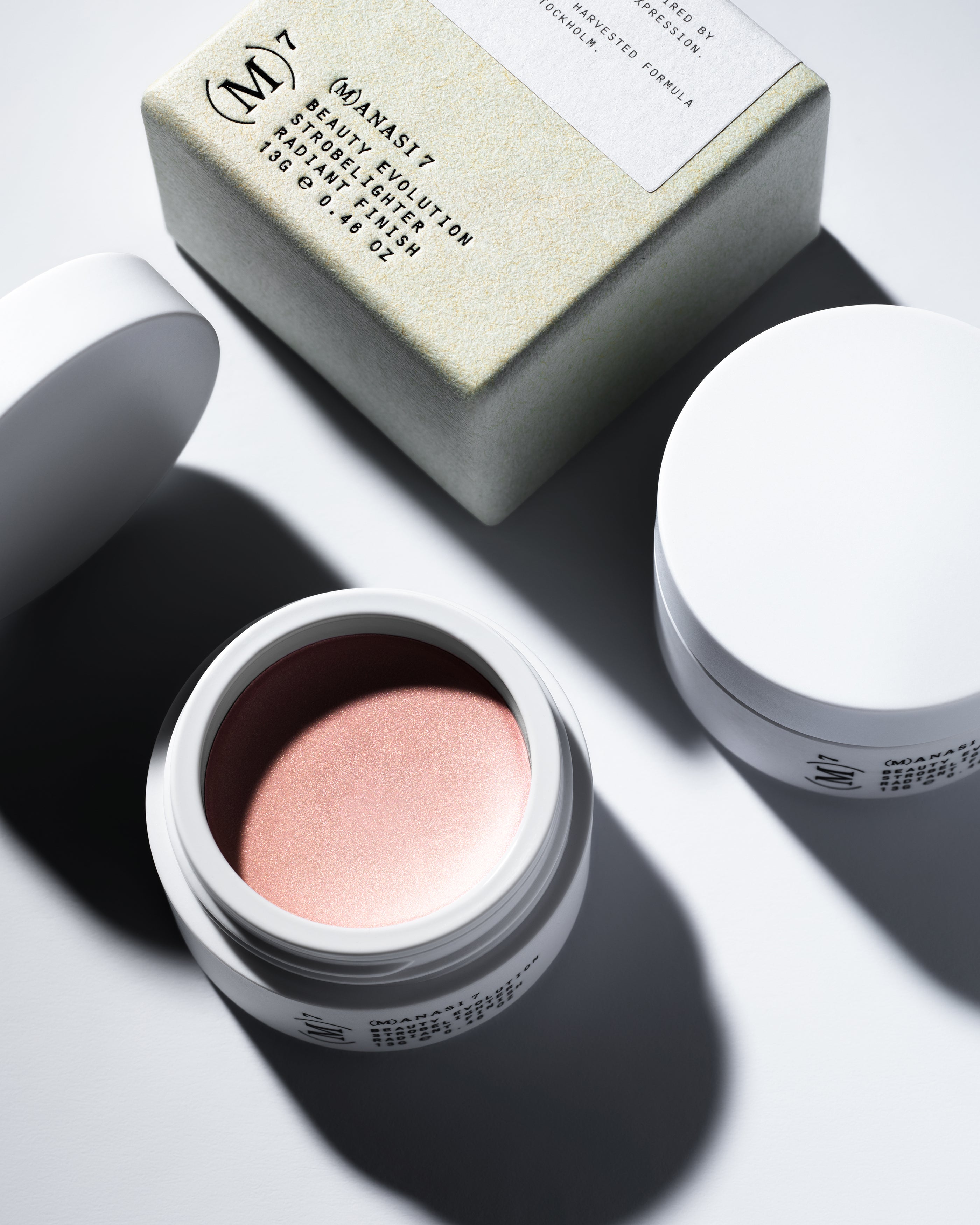 Soft peachy pearly pink tones of multi use natural and organic highlighter for all skins in minimalist white pots from Swedish make up brand Manasi7