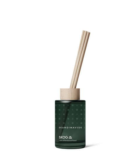Smaller sized room diffuser from Skandinavisk with the scent Skog, of the Nordic forests, in luxury dark green glass, 8 reeds and all natural and vegan scent.