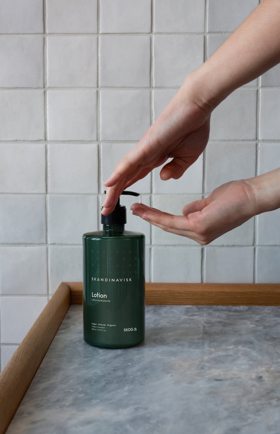 SKOG, scents of the forest, from Skandinavisk, organic, natural & vegan hand & body lotion in pump dispenser of sugarcane plastic for best sustainability values with gentle fragrances that reflect the nature and landscape of Scandinavia.