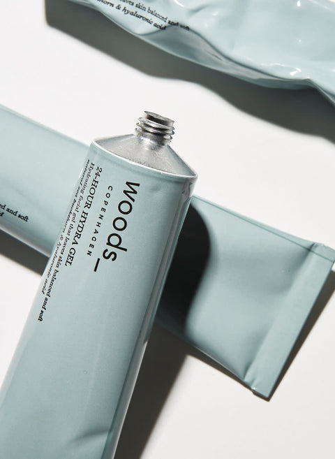 Light blue metal tube with natural, organic vegan 24 hr Hydra Gel to moisturise all skins, unisex , made by Woods Copenhagen. Great for use during sports. (8511048712497)