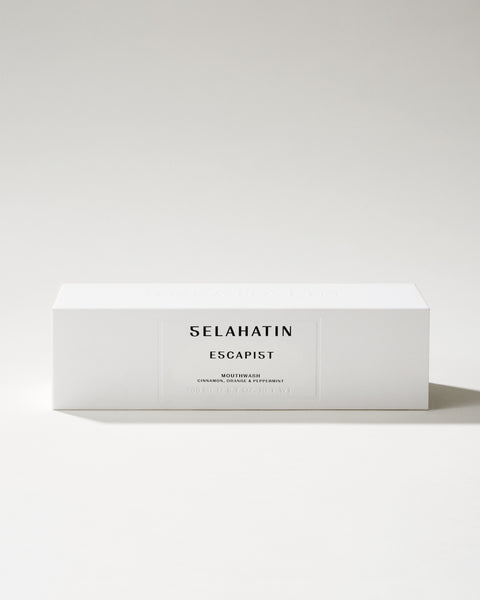 Escapist from Selahatin, vegan, natural luxury mouthwash in stylish glass bottle & white gift packaging . Gift giving for someone who has everything & the design conscious bathroom.