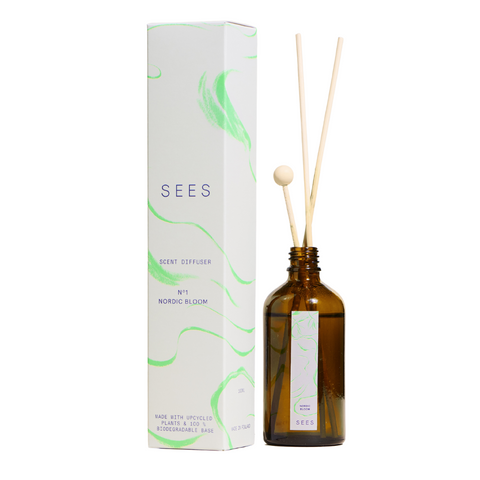 Sustainable Nordic flowers scented room diffuser for the natural home, presented in a brown glass bottle and wooden decorative sticks for a quality gift from Finland's natural lifestyle company SEES