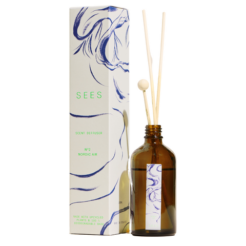 Sustainable Nordic forest scented room diffuser for the natural home, presented in a brown glass bottle and wooden decorative sticks for a quality gift from Finland's natural lifestyle company SEES