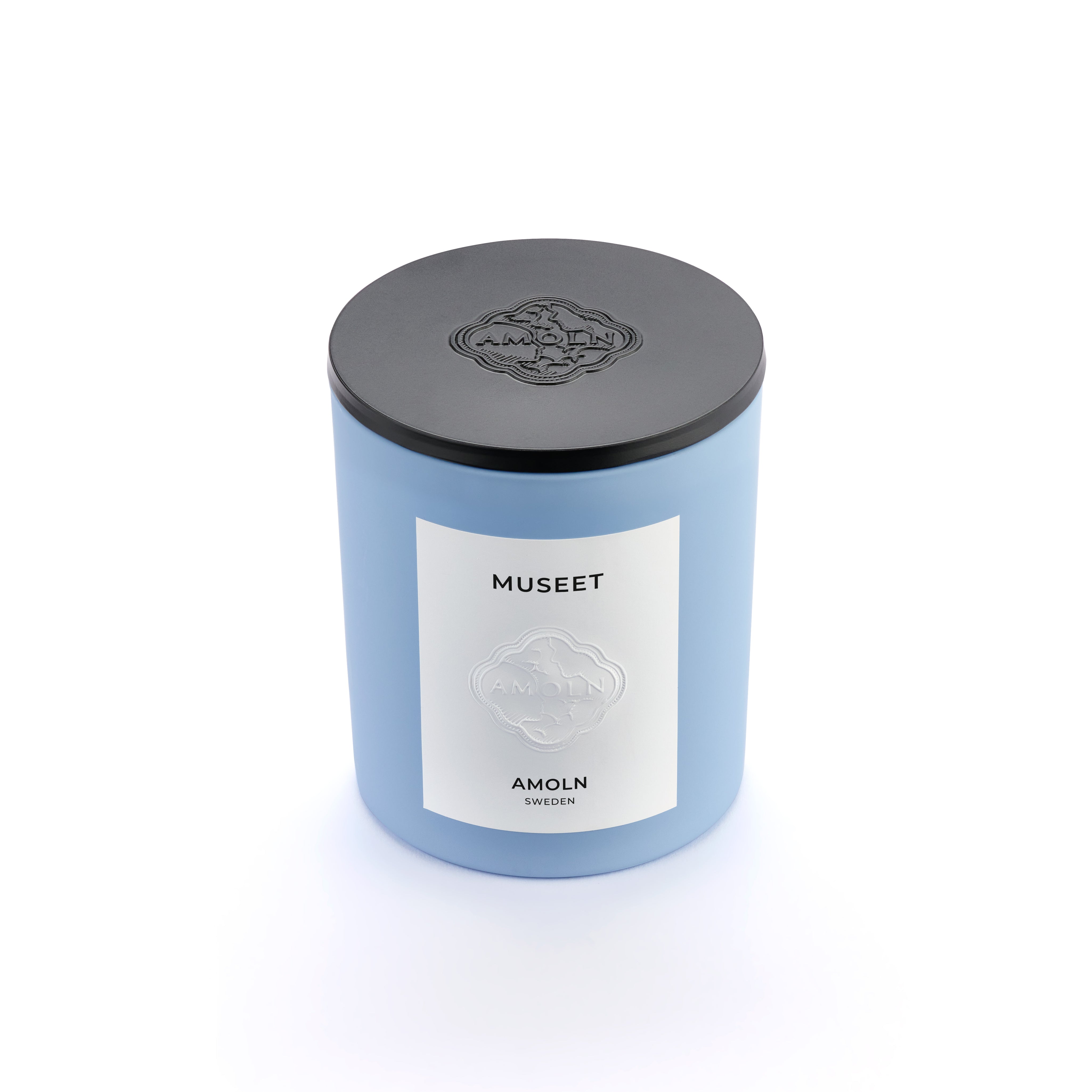 Signature blue candle in the same sky blue ceramic jar, inspired by Scandinavian skies, in the scent Museet - a blend of grapefruit, juniper, leather & violet from Amoln, makers of Sweden's royal candles.