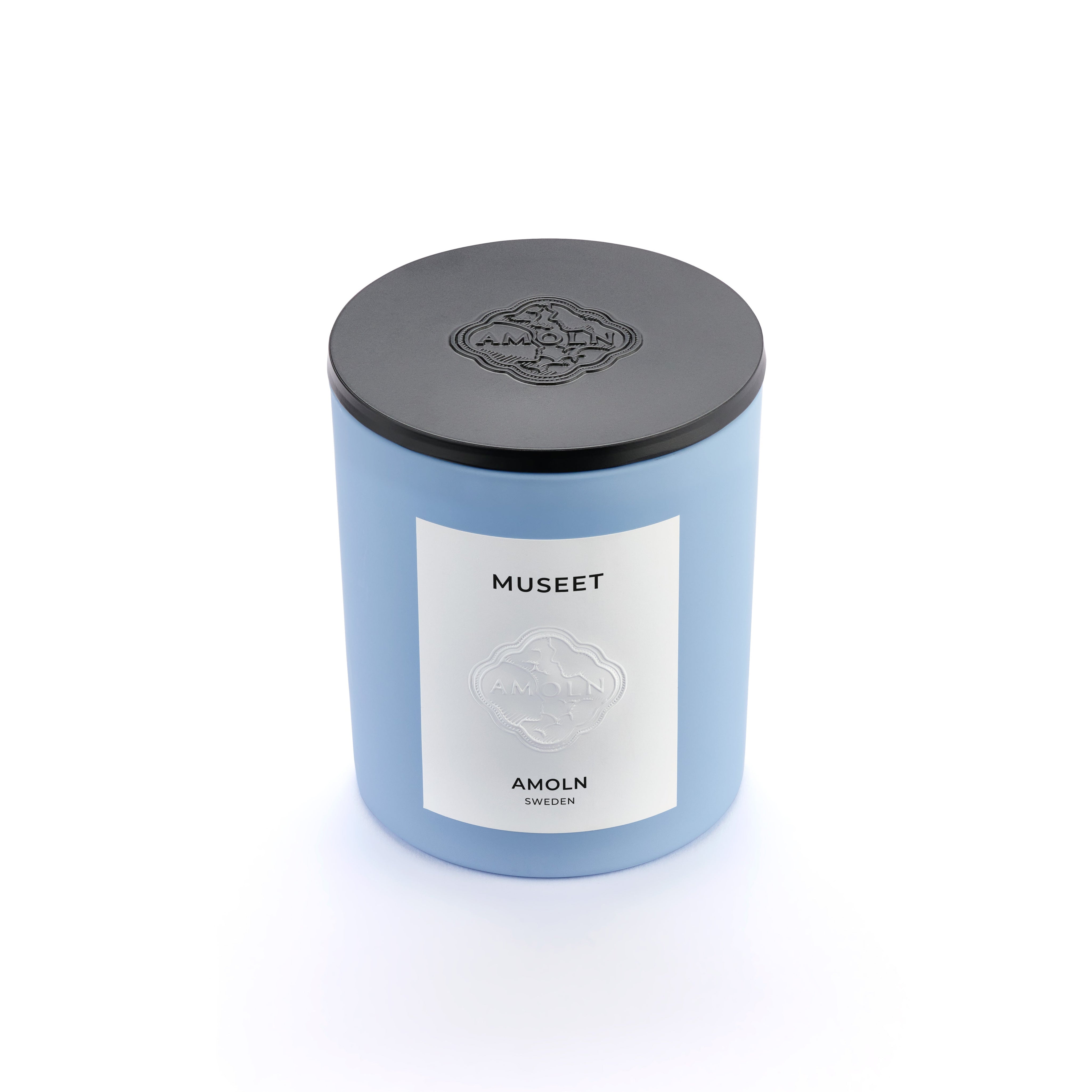 Signature blue candle in the same sky blue ceramic jar, inspired by Scandinavian skies, in the scent Museet - a blend of grapefruit, juniper, leather & violet from Amoln, makers of Sweden's royal candles.