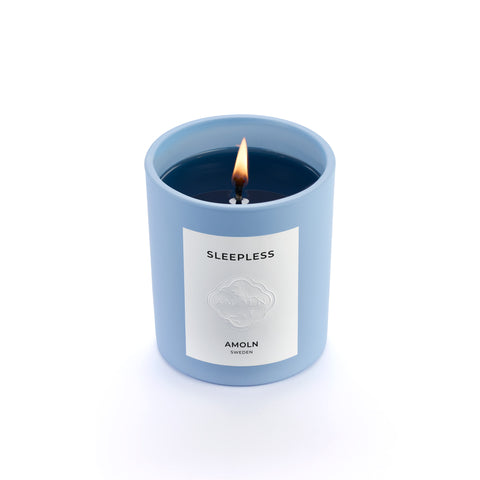 Signature blue candle in the same sky blue ceramic jar, inspired by Scandinavian skies, in the scent Sleepless - a blend of pear, lavender & sage & violet from Amoln, makers of Sweden's royal candles.