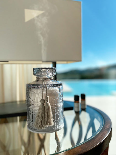 Grey cut glass aromatherapy diffuser with elegant tassel. Charge up with USB cable and control with remote for different light settings. from STHLM Fragrance Supplier