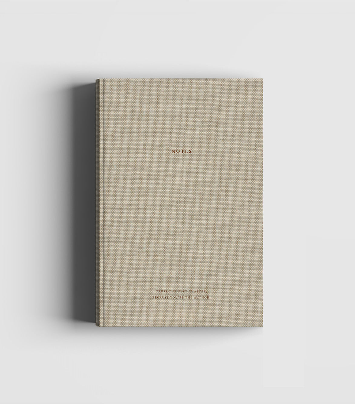 Natural beige linen hard cover notebook with gold foil text 'Just Enjoy Where You Are Now' with blank pages for notes, sketches, poems and more, produced sustainably by Cozy Publishing.