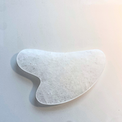 Rock crystal gua sha stone for facial massage and home treatment rituals