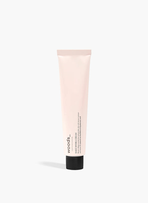 Light pink metal tube with natural, organic vegan Daily Hydra Cream to moisturise all skins, unisex , made by Woods Copenhagen.
