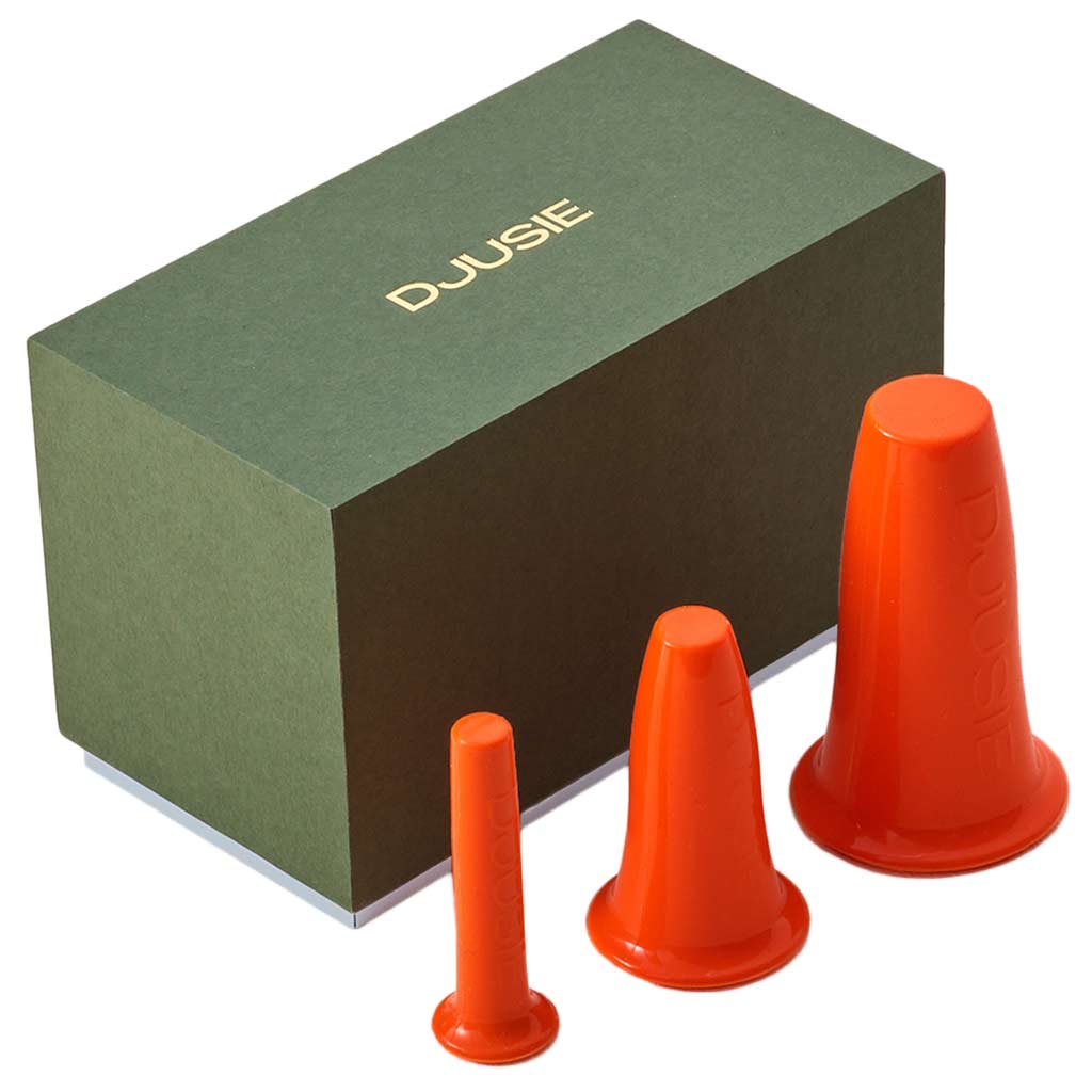 Orange silicone cups for facial cupping to aid drainage and skin tone, i n a green gift box from Djusie, Finland&#39;s leading organic skincare brand