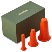 Orange silicone cups for facial cupping to aid drainage and skin tone, i n a green gift box from Djusie, Finland's leading organic skincare brand