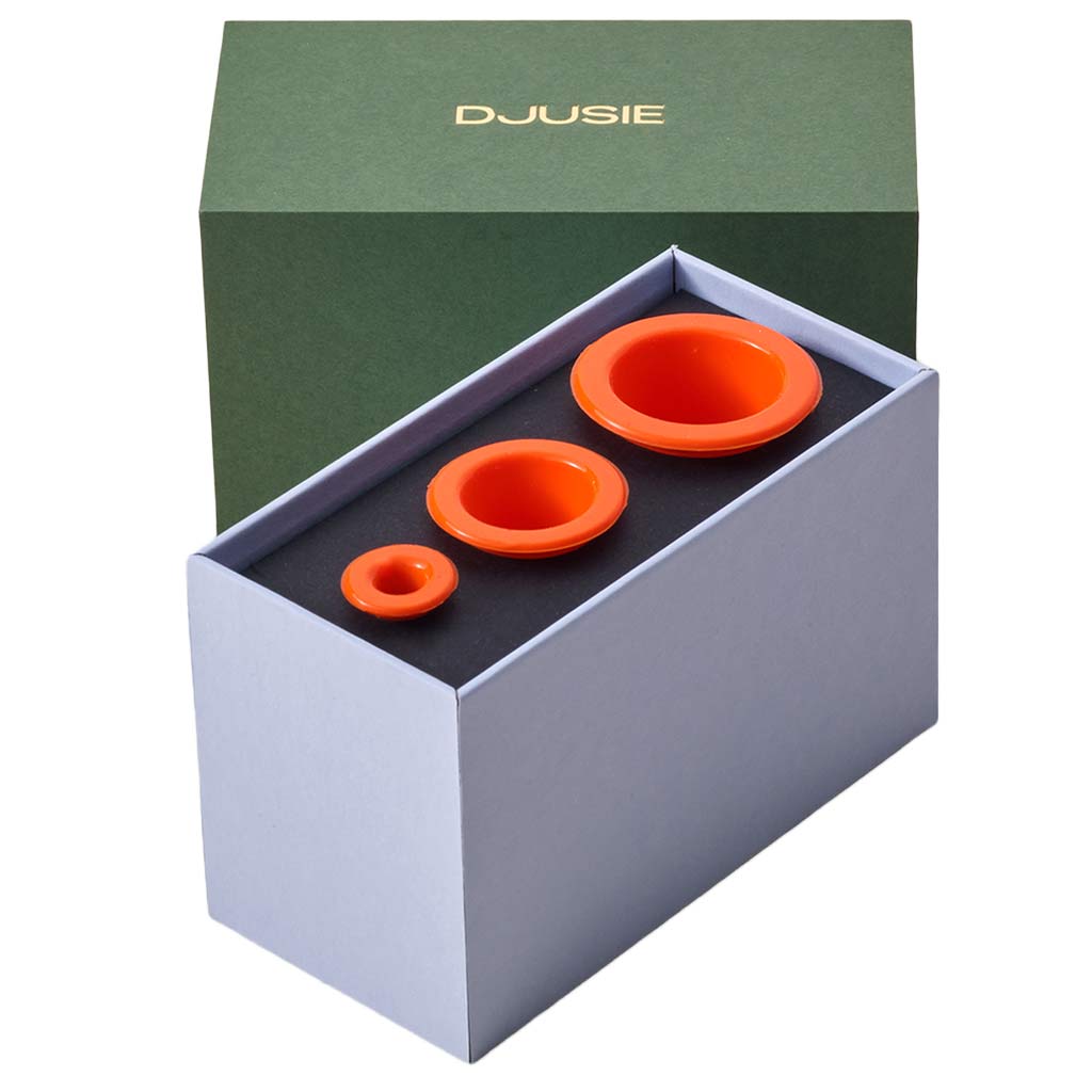 Orange silicone cups for facial cupping to aid drainage and skin tone, i n a green gift box from Djusie, Finland's leading organic skincare brand