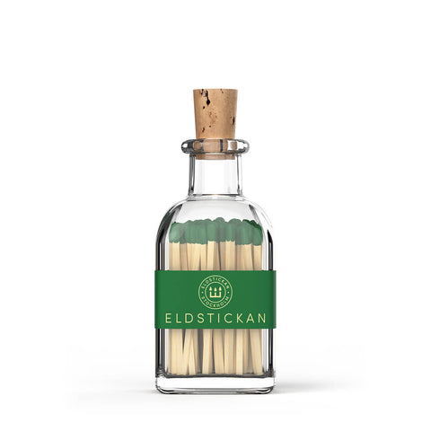 Green coloured matches in a stylish glass bottle from Eldstickan for a great interior design idea