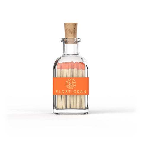Orange coloured matches in a stylish glass bottle from Eldstickan for a great interior design idea