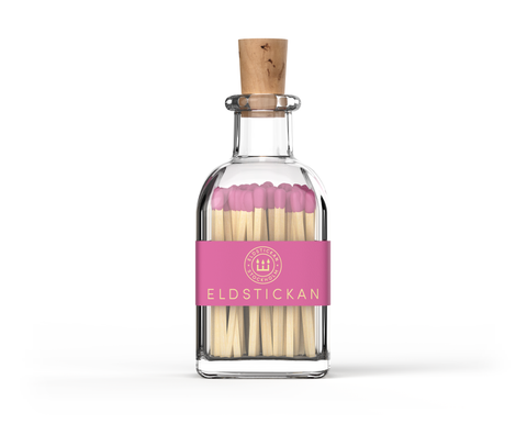 Bright pink coloured matches in a stylish glass bottle from Eldstickan for a great interior design idea