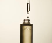 Dropper bottle of hair and scalp oil to tame frizz and itchy scalp naturally from Luare