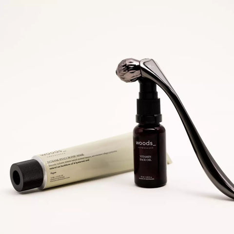 Steel coloured metal sculpting tool with faceted rollers to improve skin tone and circulation, boosting collagen production and for home facial treatments is a great luxury gift to upgrade your skincare routine from Woods Copenhagen.