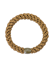 Kknekki hazlenut original hair tie in yellow brown shade with khaki iconic logo bead.