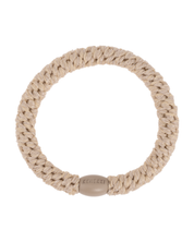 Kknekki wheat glitter hair tie in neutral tones with beige iconic logo bead.
