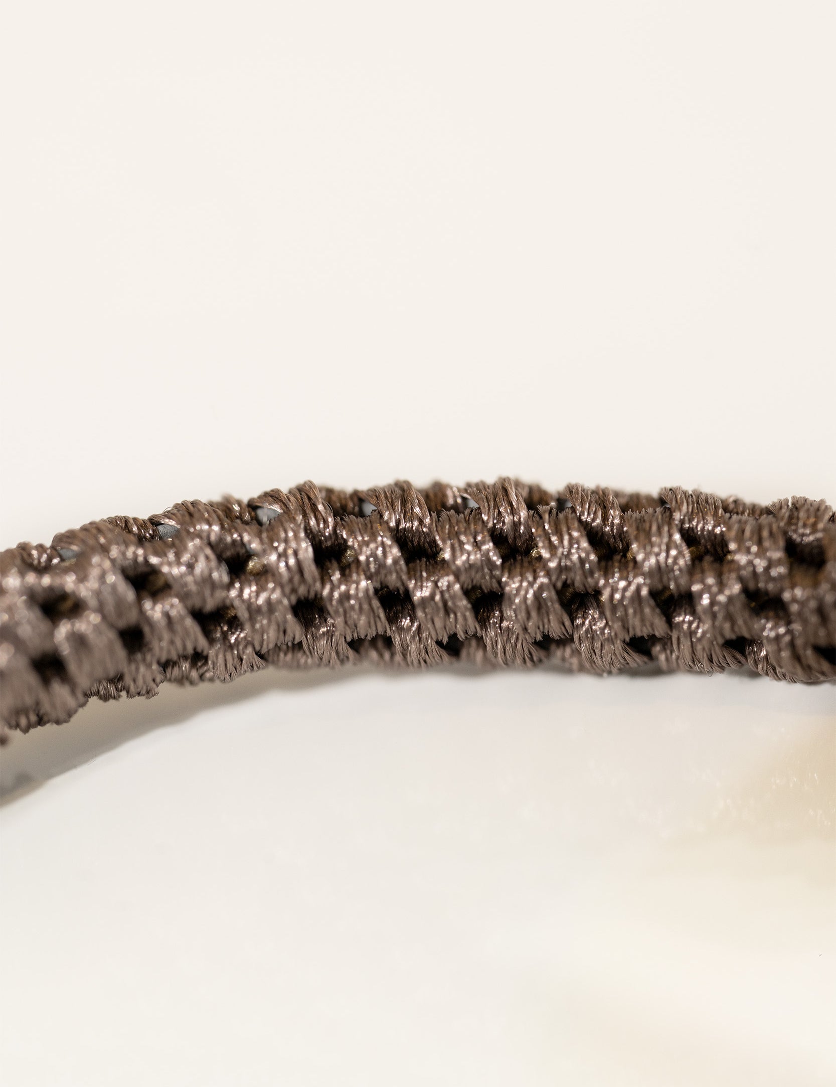 Close up of the iconic KKNEKKI hair tie in a rich brown shade