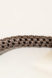 Close up of the iconic KKNEKKI hair tie in a rich brown shade
