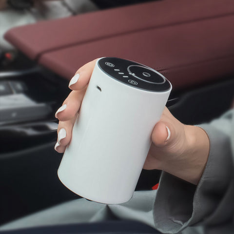 Modern white portable essential oil diffuser, ideal to use in the car, at your desk or anywhere without the need for a cable or wall outlet. No water - simply screw in the essential oil 10ml bottle.