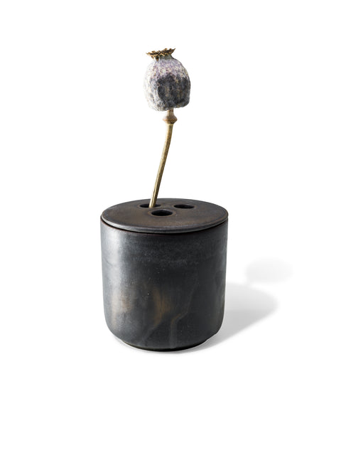 refill or reuse the ceramic vessel once the candle is over, in unique black textured finish from Quod Stockholm with distinctive 3 hole ceramic lid designed for flowers, twigs and natural arrangements.