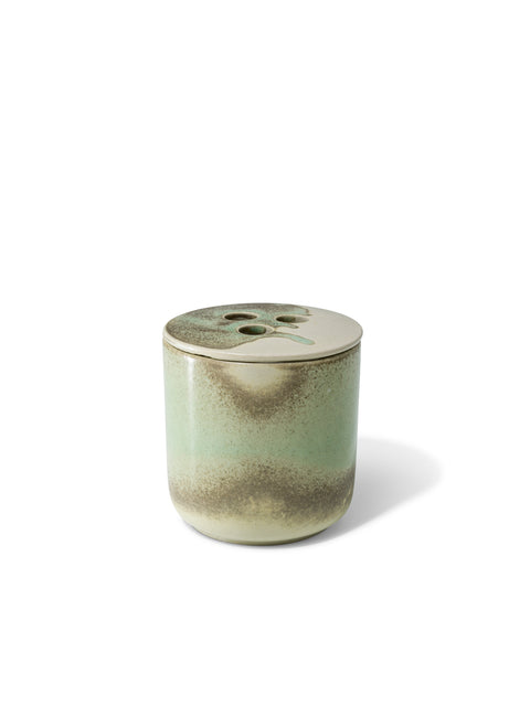 Elegant design and natural sophisticated scent of dry vetiver in this refillable ceramic candle in unique green & beige textured finish from Quod Stockholm, with a distinctive 3 hole ceramic lid