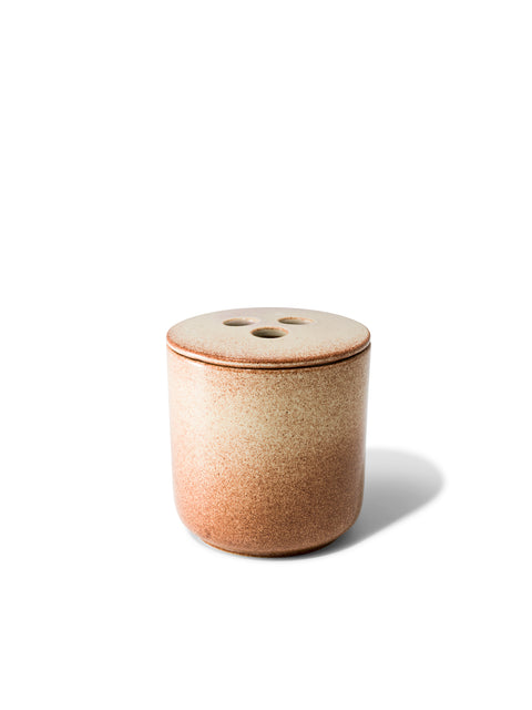 Elegant design and natural sophisticated scent of amber & rose in this refillable ceramic candle in unique rust & beige textured finish from Quod Stockholm, with a distinctive 3 hole ceramic lid