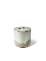 Elegant design and natural sophisticated scent of banira wood in this refillable ceramic candle in unique white & beige textured finish from Quod Stockholm, with a distinctive 3 hole ceramic lid