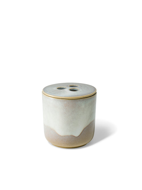 Elegant design and natural sophisticated scent of banira wood in this refillable ceramic candle in unique white & beige textured finish from Quod Stockholm, with a distinctive 3 hole ceramic lid