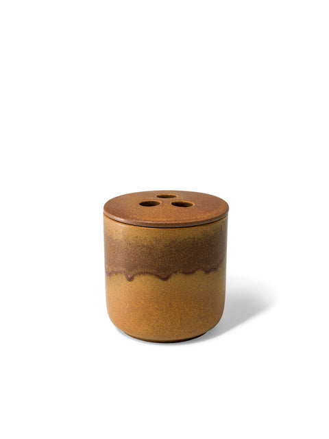 Elegant design and natural sophisticated scent of Forest Fable with its woody citrus notes, in this refillable ceramic candle in unique earthy brown textured finish from Quod Stockholm, perfect for any home