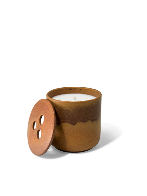 Elegant design and natural sophisticated scent of Forest Fable with its woody citrus notes, in this refillable ceramic candle in unique earthy brown textured finish from Quod Stockholm, with distinctive 3 holed lid