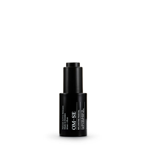 Sleek black glass bottle with stark white text creates a stylish minimalist skincare line from OM-SE. This balancing facial oil is vegan and totally organic for easy beauty routines, ideal for acne skin problems.