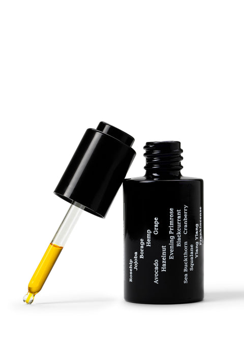 Sleek black glass bottle with stark white text creates a stylish minimalist skincare line from OM-SE. This balancing facial oil is vegan and totally organic for easy beauty routines, ideal for acne & problem skin.