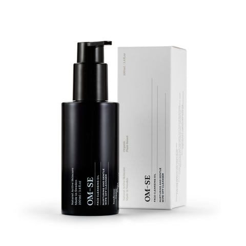 Sleek black glass bottle with stark white text, delivered in sustainable luxury white packaging creates a stylish minimalist skincare line from OM-SE. This cleansing oil is vegan and totally organic for easy beauty routines.