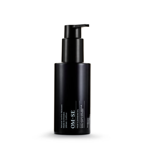 Sleek black glass bottle with stark white text creates a stylish minimalist skincare line from OM-SE. This cleansing oil is vegan and totally organic for easy beauty routines.