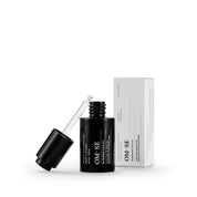 Sleek black glass bottle with stark white text in white packaging creates a stylish minimalist skincare line from OM-SE. This renewing facial oil is vegan and totally organic for easy beauty routines, ideal for dry & ageing skin.