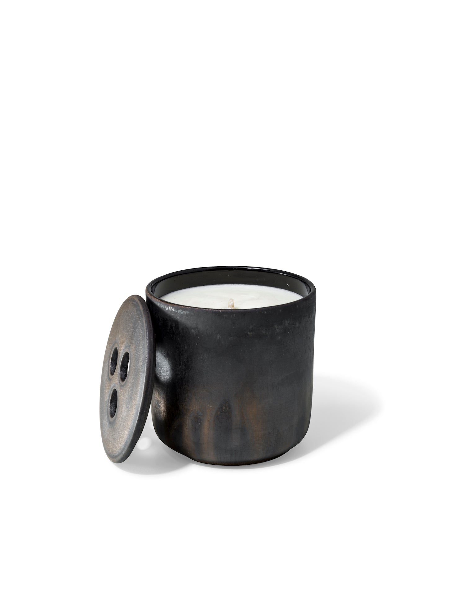 Elegant design and natural sophisticated scent of black wood in this refillable ceramic candle in unique textured finish from Quod Stockholm, with distinctive 3 hole ceramic lid