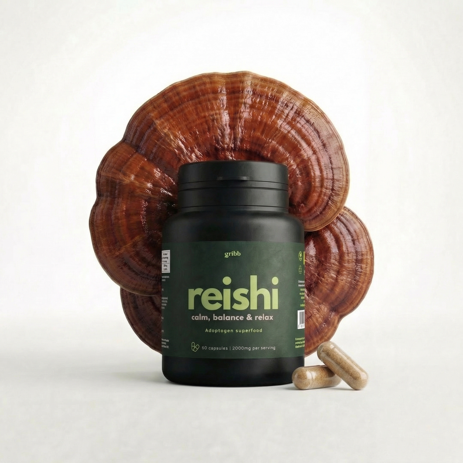 Supplement bottle labeled 'reishi' with a large reishi mushroom on a white background